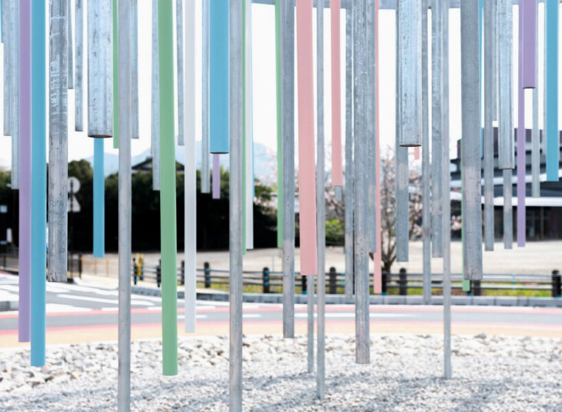 Roundabout installation by takao shiotsuka workshop drips like paint through colored steel pipes