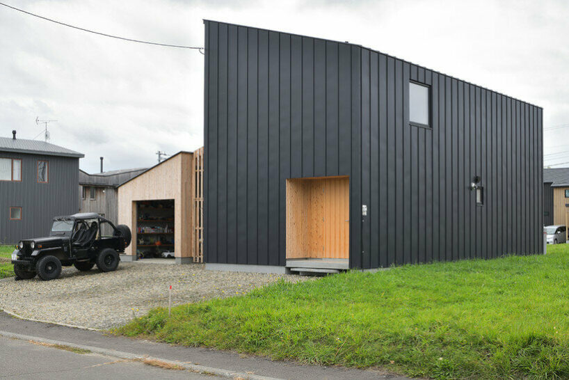 ryuji yamashita divides a building into two for its 'garage house' in hokkaido