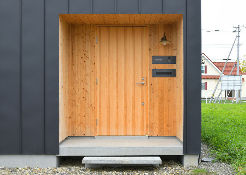 ryuji yamashita divides a building into two for its 'garage house' in hokkaido, japan