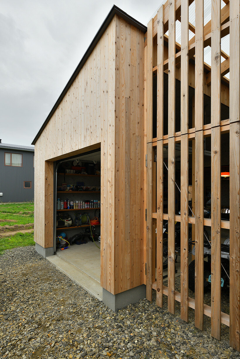 ryuji yamashita divides a building into two for its 'garage house' in hokkaido, japan