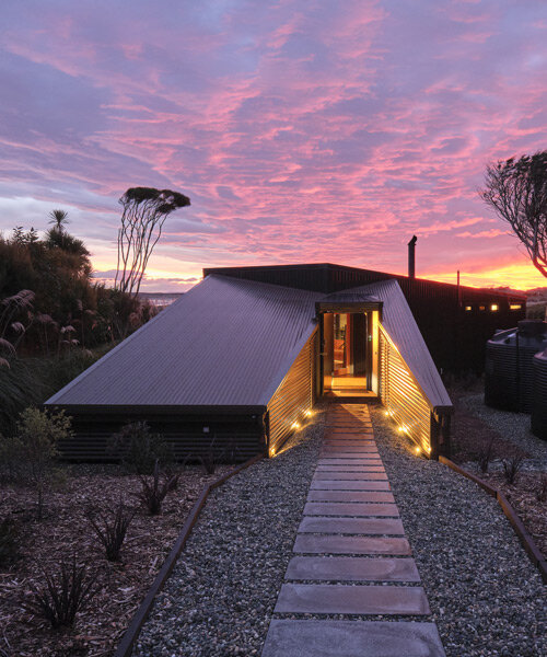 stacey farrell-designed 'coast house' hunkers down among new zealand dunes