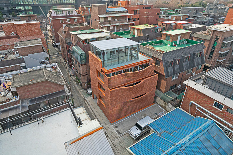 undulating red brick facade envelops 'wave' commercial building by JYA-rchitects in seoul