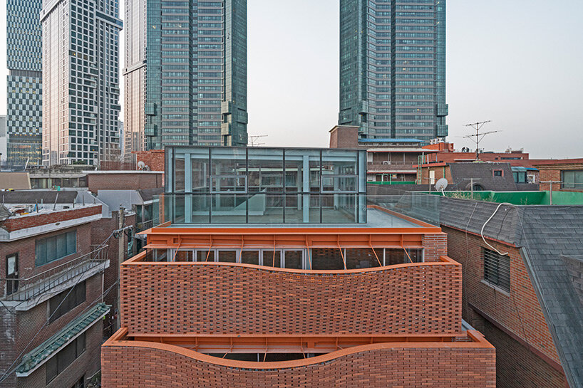 undulating red brick facade envelops 'wave' commercial building by JYA-rchitects in seoul