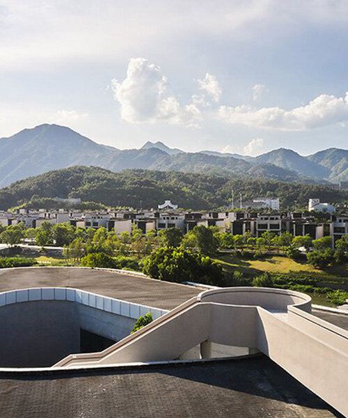 winding staircase of g-lake art gallery culminates with scenic views of chinese mountainscape