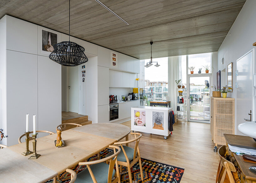 BIG's modular housing spirals around central pond in danish sustainable suburb