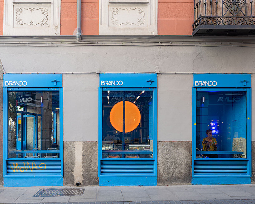 circular 'sun' lamp illuminates blue brando ice cream shop in madrid