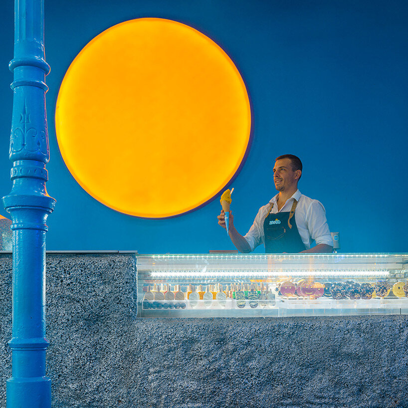 circular 'sun' lamp illuminates blue brando ice cream shop in madrid