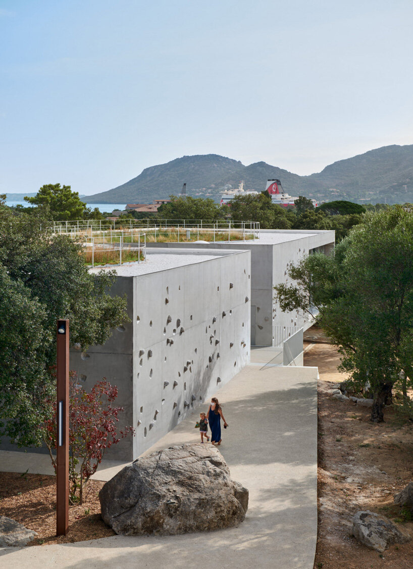 dominique coulon animu media library's concrete curves embrace the site's existing landscape in porto-vecchio