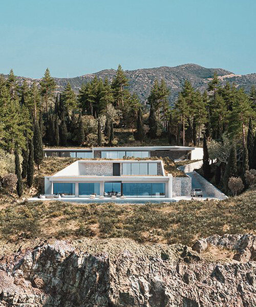 studio façade wedges a white-prismed villa into the greek cliffs of lefkada