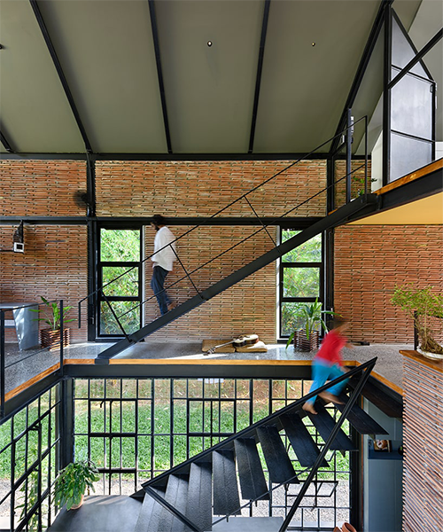 repurposed factory tiles and pivoted glazing define permeable residence in india