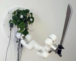 living plant controls a machete through an industrial robot arm