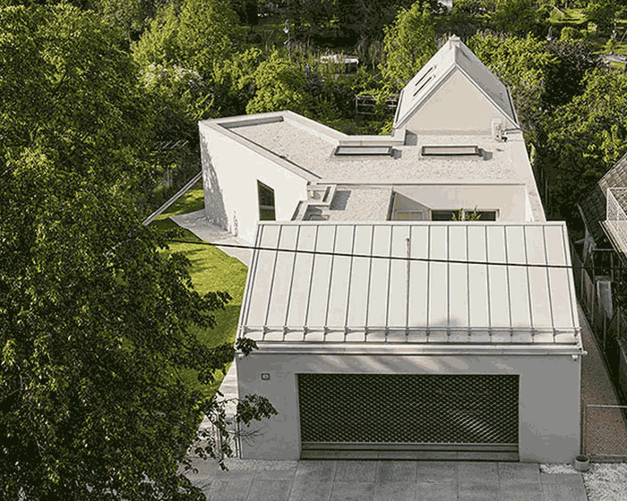 set within the green polish landscape, this V-shaped house prioritizes natural lighting