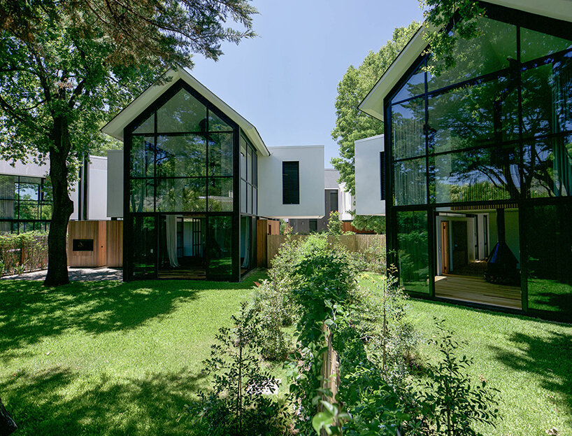 nestled in a cross-shaped plan, these duplex houses in uruguay boast striking visual rhythms