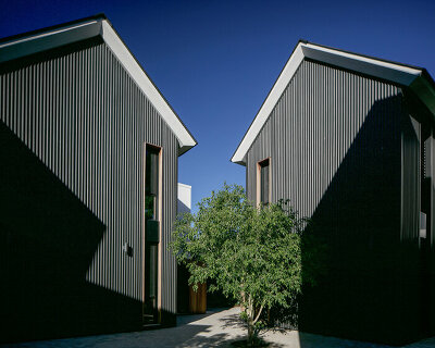 nestled in a cross-shaped plan, these duplex houses in uruguay boast striking visual rhythms