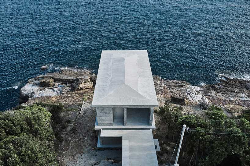 ninkipen! perches concrete seaside house on rugged national park landscape in japan