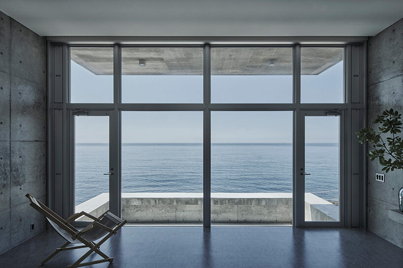 ninkipen! perches concrete seaside house on rugged national park landscape in japan