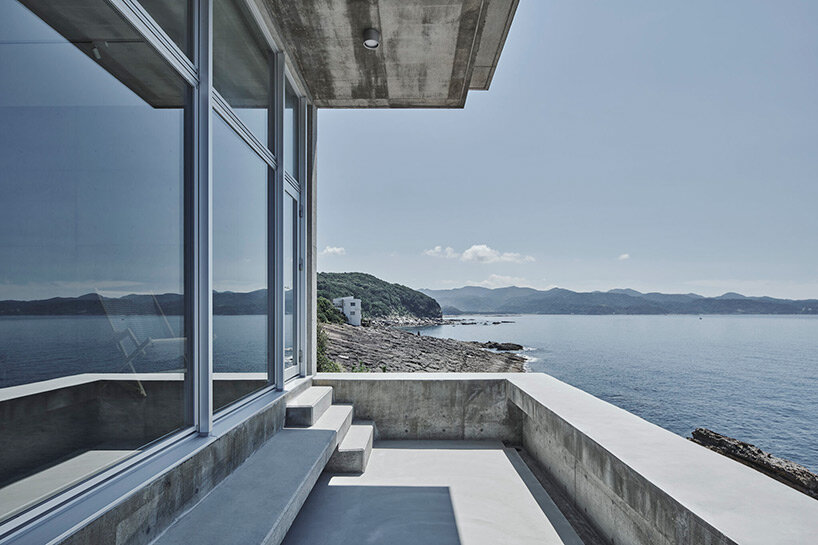 ninkipen! perches concrete seaside house on rugged national park landscape in japan