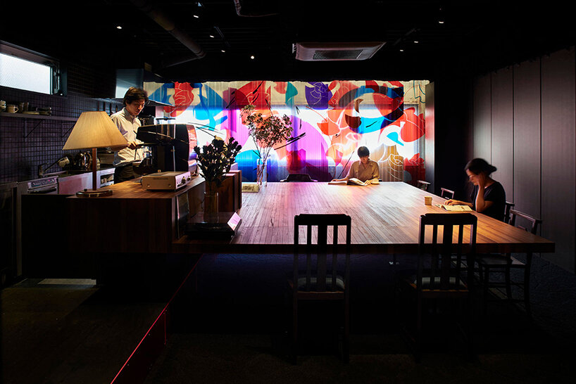 a movable, pleated artwork floods this japanese cafe with a homely ambiance