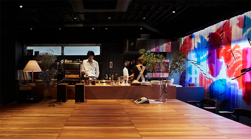 a movable, pleated artwork floods this japanese cafe with a homely ambiance