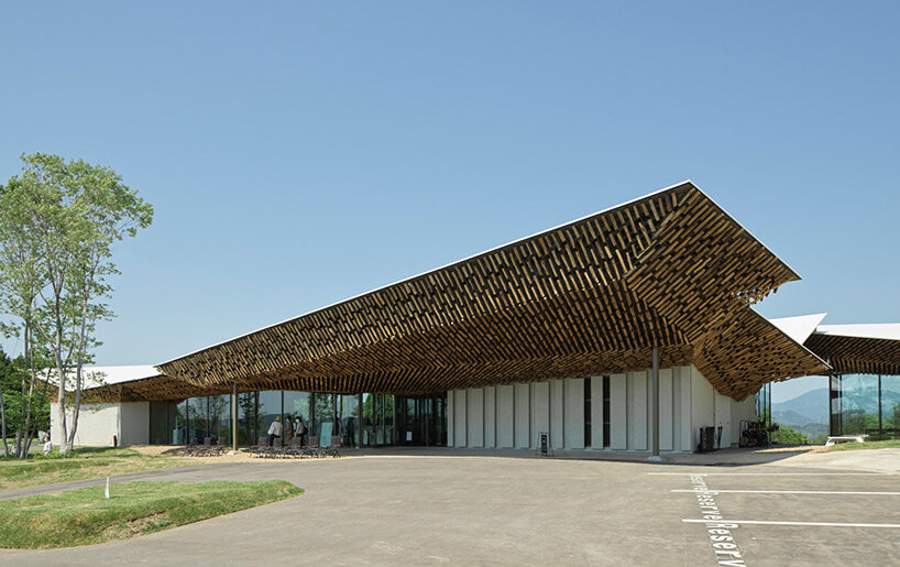 kengo kuma's firewood roof for 'snow peak' spa resort echoes