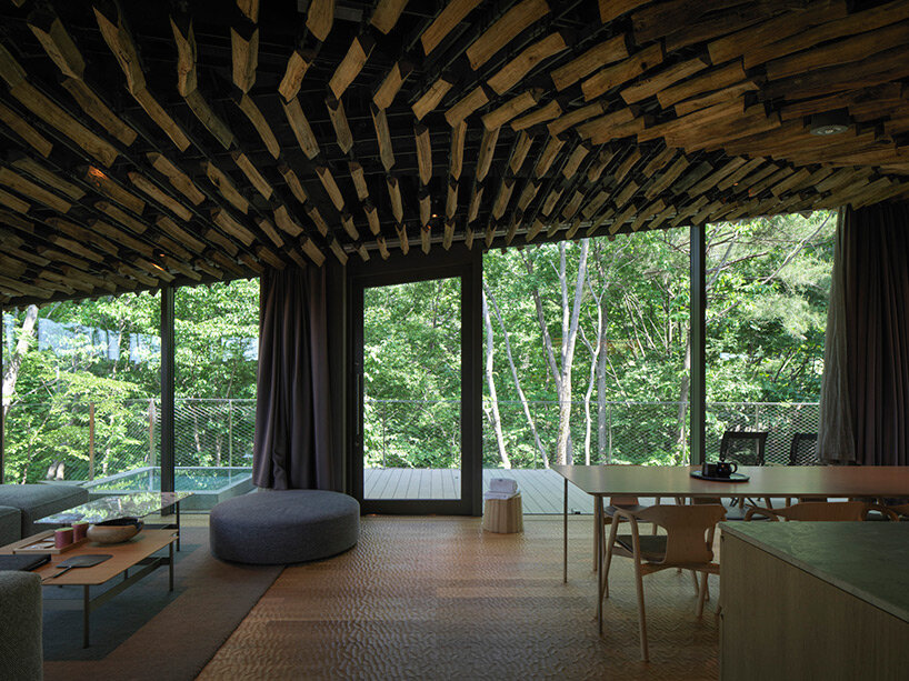 kengo kuma's firewood roof for 'snow peak' spa resort echoes mountain ridgeline in japan