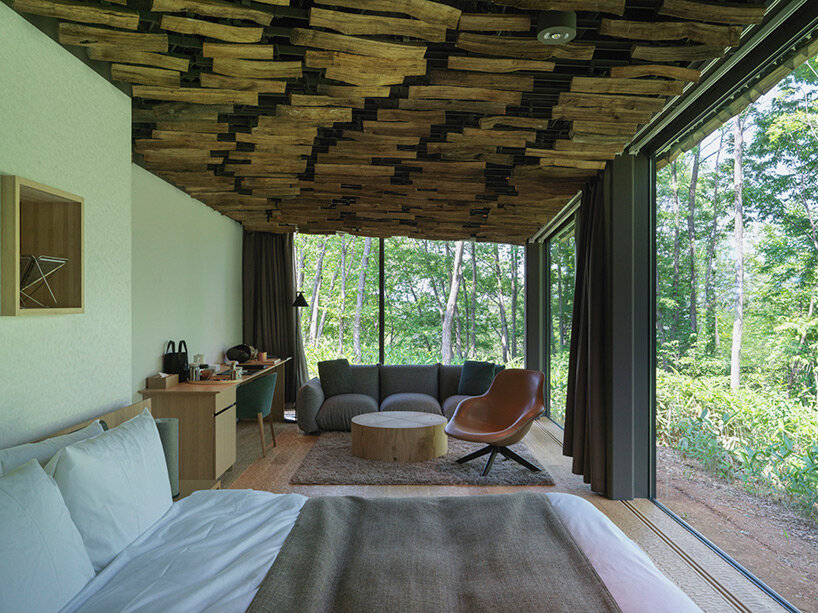 kengo kuma's firewood roof for 'snow peak' spa resort echoes mountain ridgeline in japan