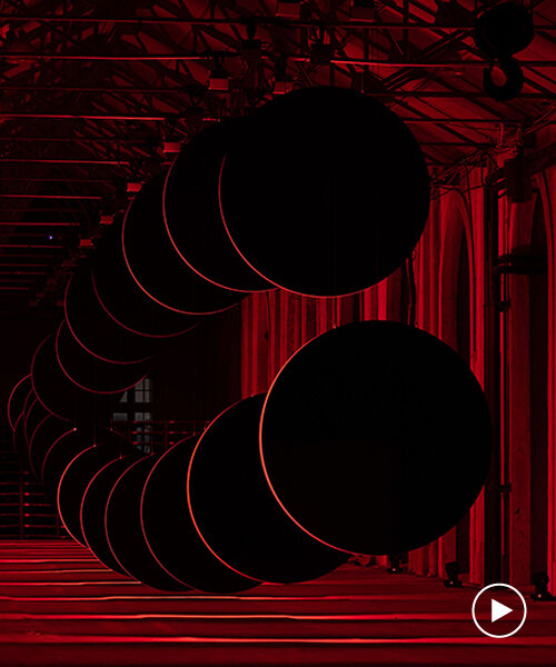 20 large discs move hypnotically against a red-lit backdrop in SpY's latest kinetic artwork