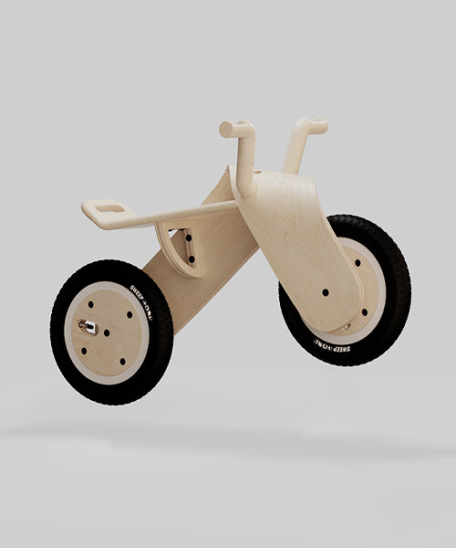 bored eye design sculpts children's balance bike using a sweeping, wooden form