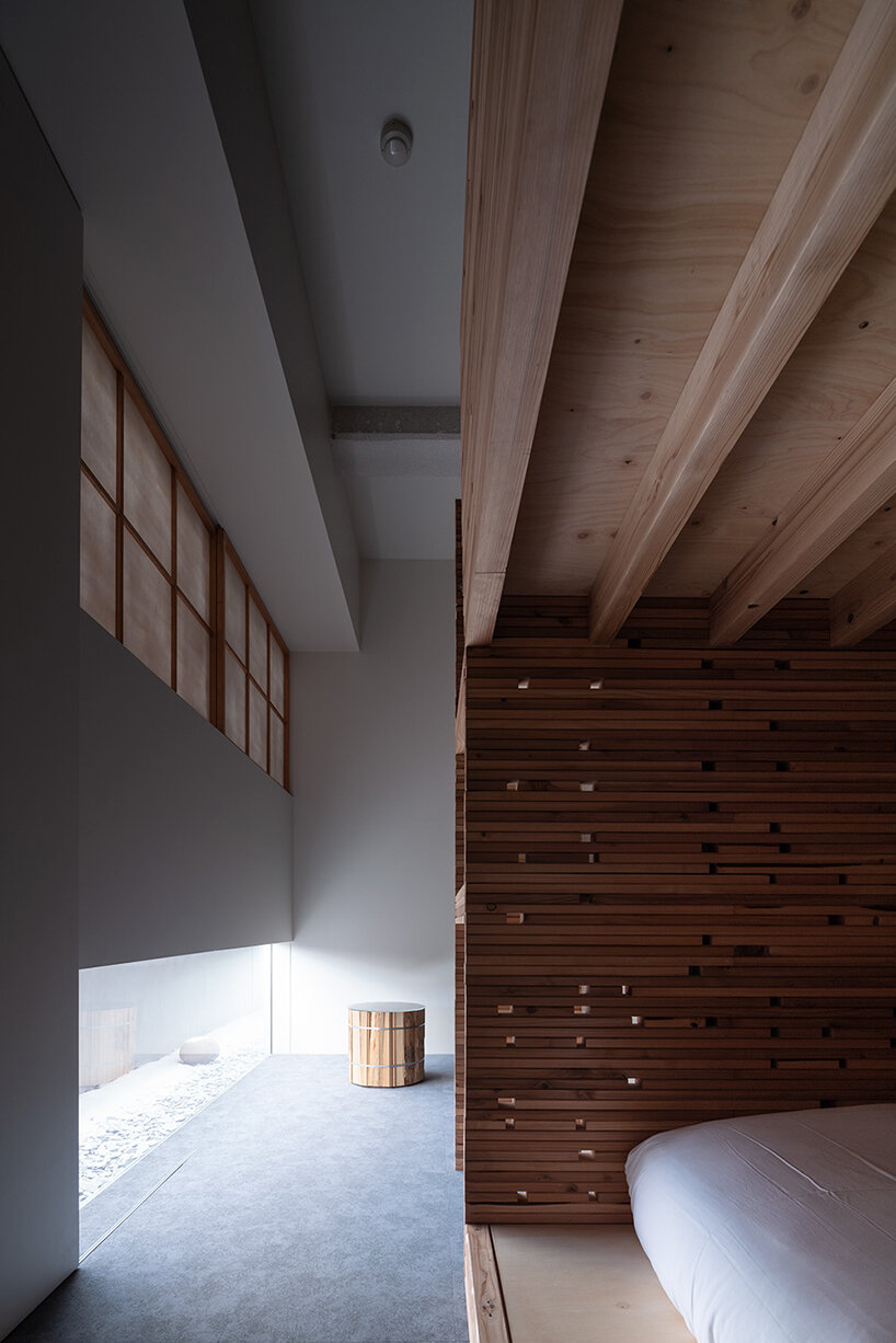 fronted with a porous wooden facade, the 'takayama hotel' in japan evokes a forestscape