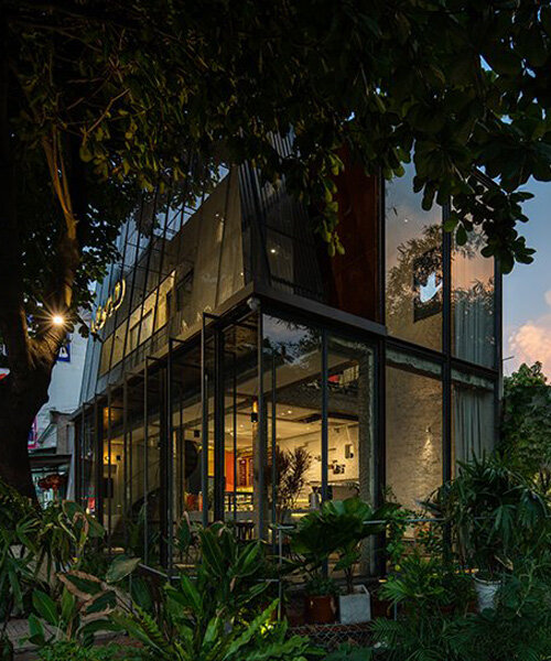 A+H architects wraps vietnam café with large, rotating glass doors + perforated steel panels
