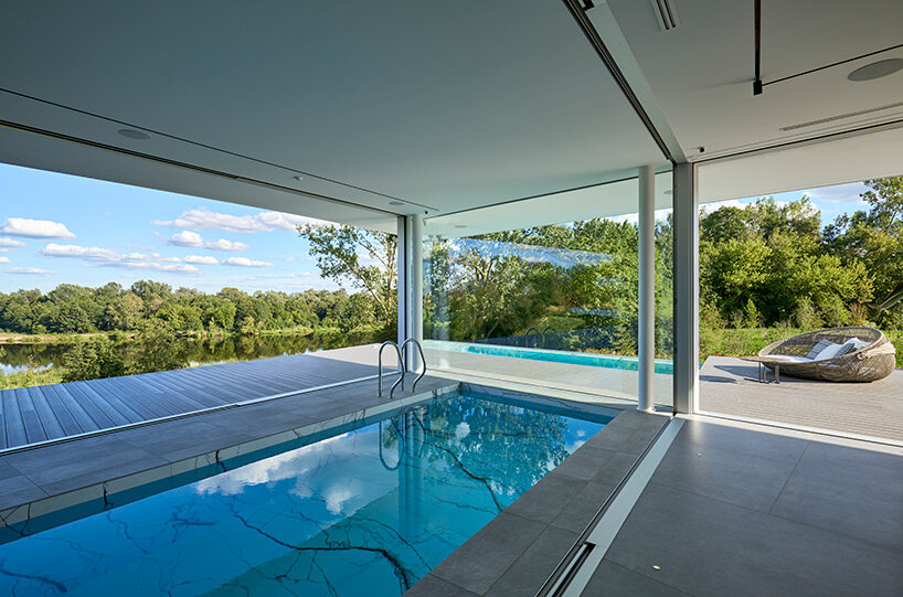 mobius architekci carves dune-shaped residence into lush hillside site in poland