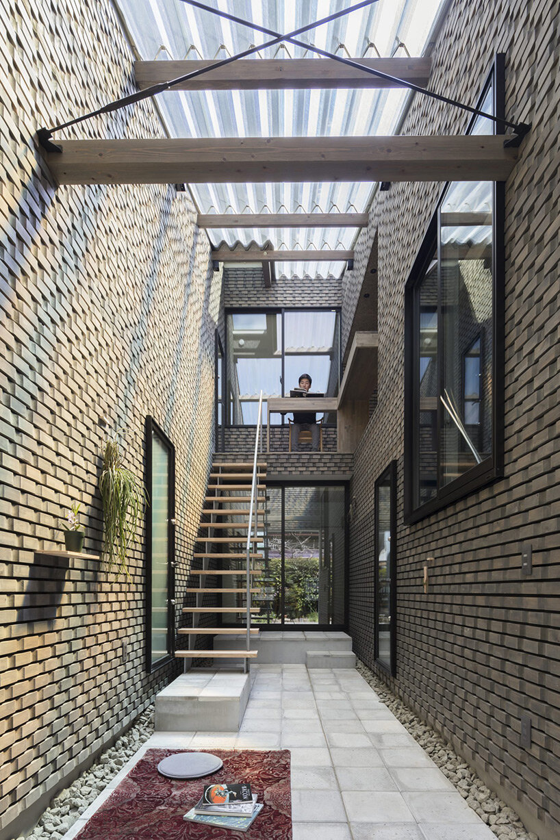 sato+ lodges semi-open house with transparent roof into narrow alley in sendai, japan