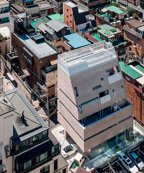 stacked brick multi-level building renders floating illusion in seoul's most popular avenue
