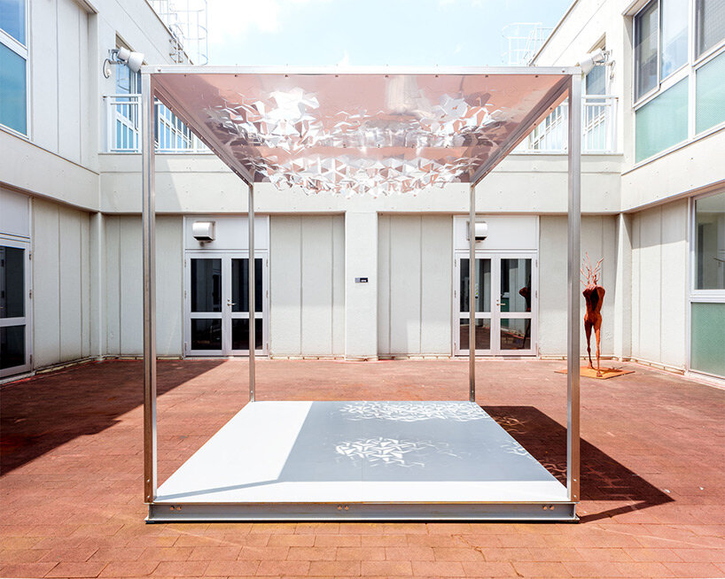 drawing from japanese paper cutting art, the auxetic pavilion filters sunlight like a tree