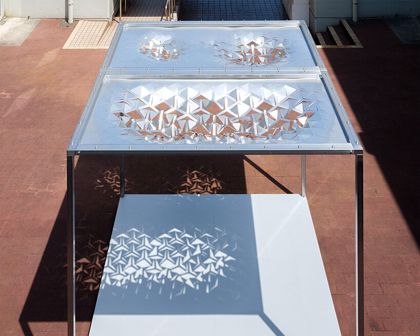 drawing from japanese paper cutting art, the auxetic pavilion filters sunlight like a tree