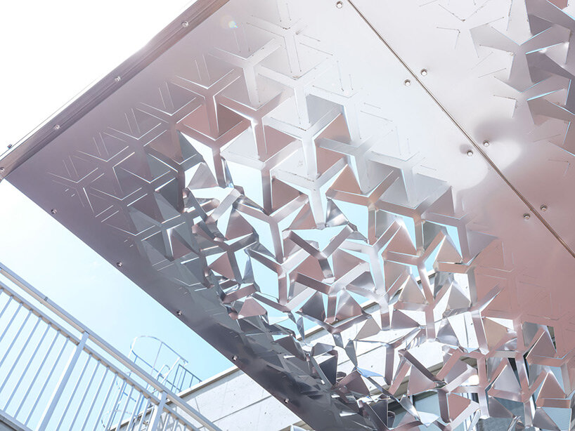 drawing from japanese paper cutting art, the auxetic pavilion filters sunlight like a tree