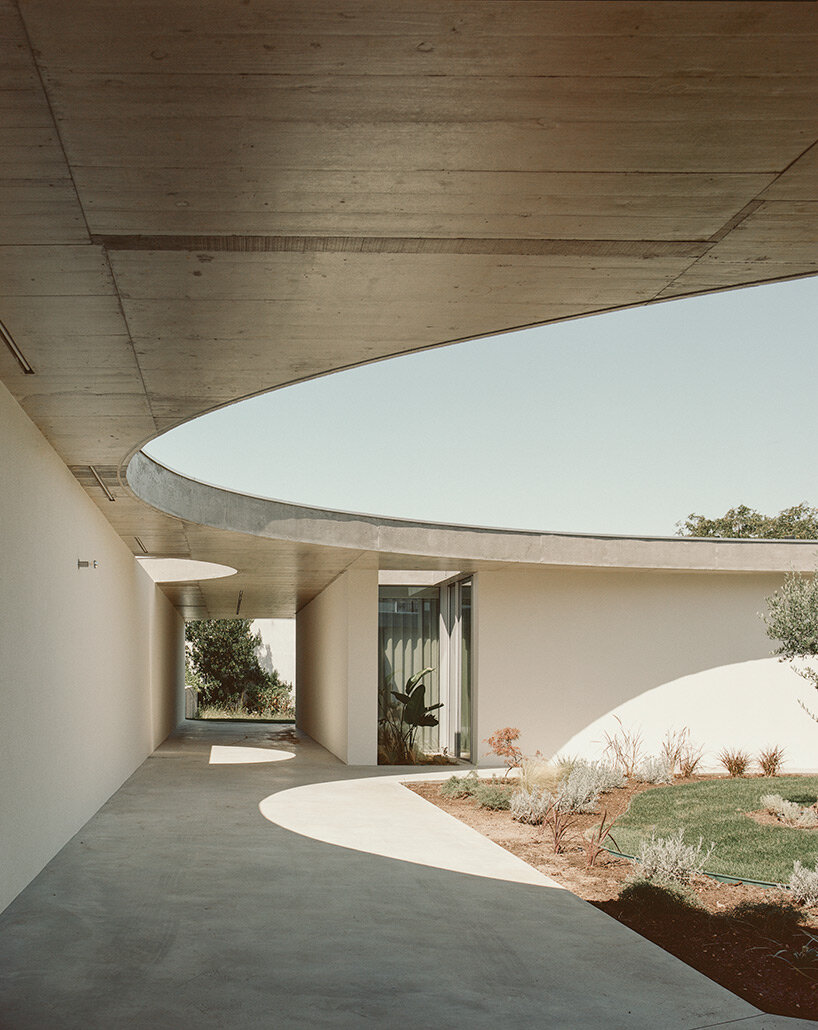 verdant circular patios contrast with orthogonal forms in bruno dias' casa âmago in portugal