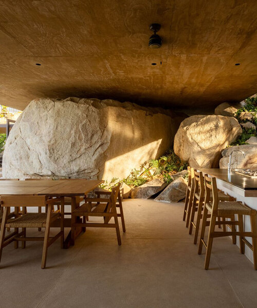 gabriela carrillo's 'casa piedra' lightly hovers over the boulders of its cliffy site