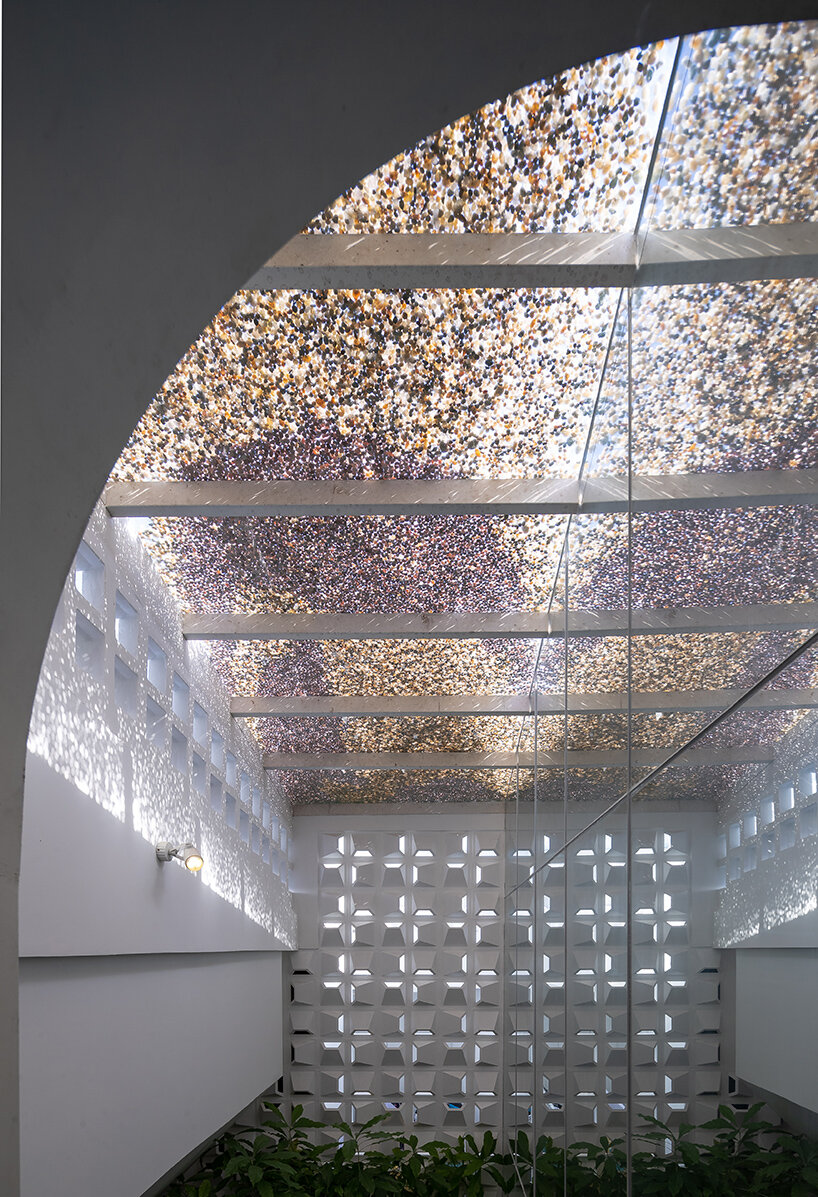 a renovated glass-brick volume, 'coco house' in vietnam evokes otherworldly nostalgia