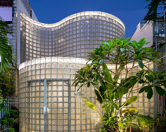 a renovated glass-brick volume, 'coco house' in vietnam evokes otherworldly nostalgia