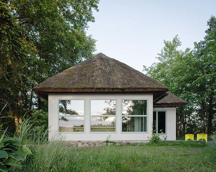 revived thatched cottage shelters a vibrant getaway along the german lakeside