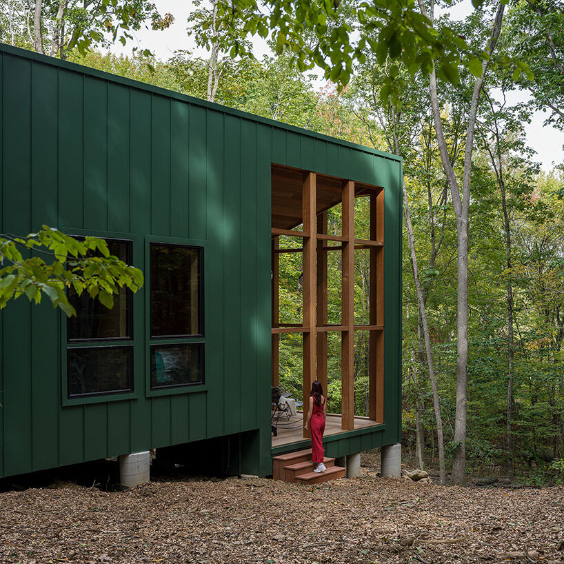 secluded cabin by scalar architecture hovers lightly above sloping terrain in connecticut