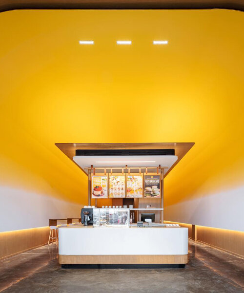 cave café in canada shines like the sun with yolk yellow interior