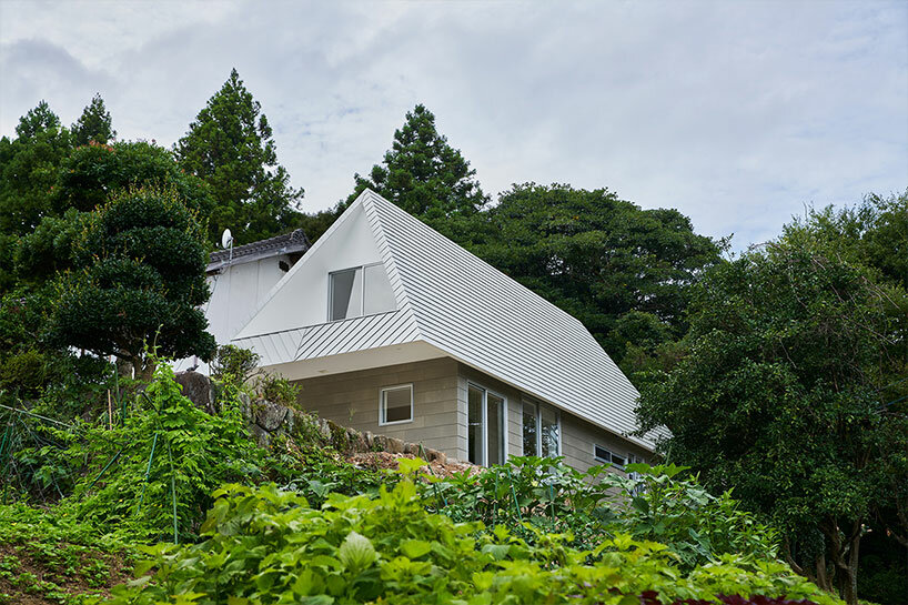 cut-out triangular roof frames extensive panoramas of rural japan