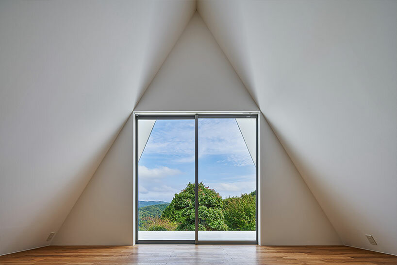 cut-out triangular roof frames extensive panoramas of rural japan