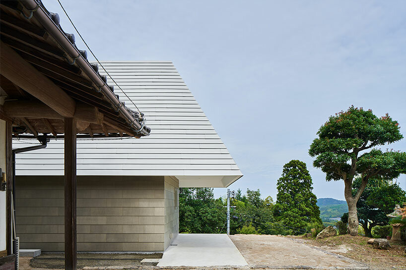 cut-out triangular roof frames extensive panoramas of rural japan