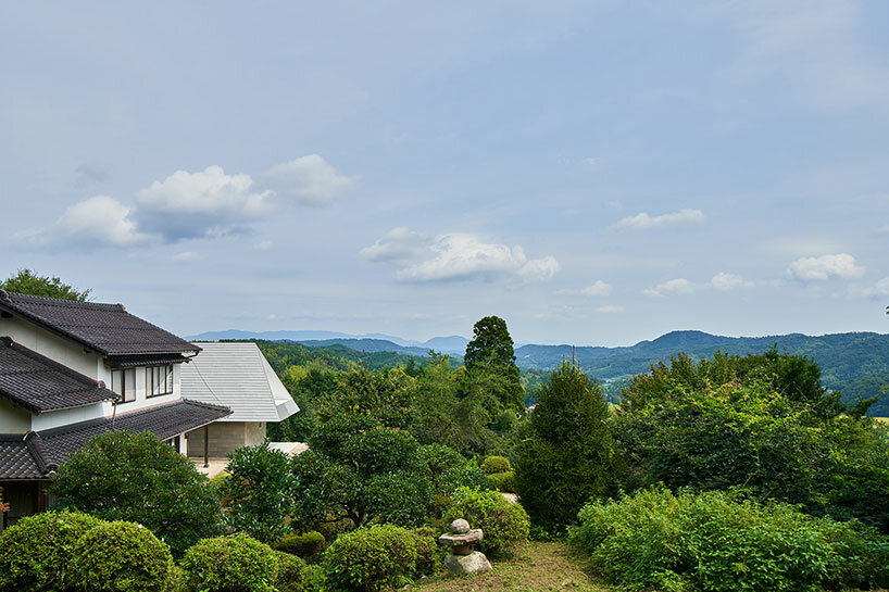 cut-out triangular roof frames extensive panoramas of rural japan