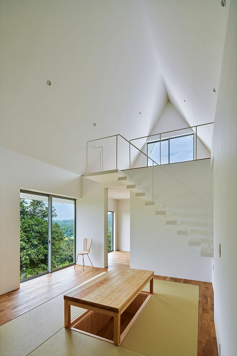 cut-out triangular roof frames extensive panoramas of rural japan