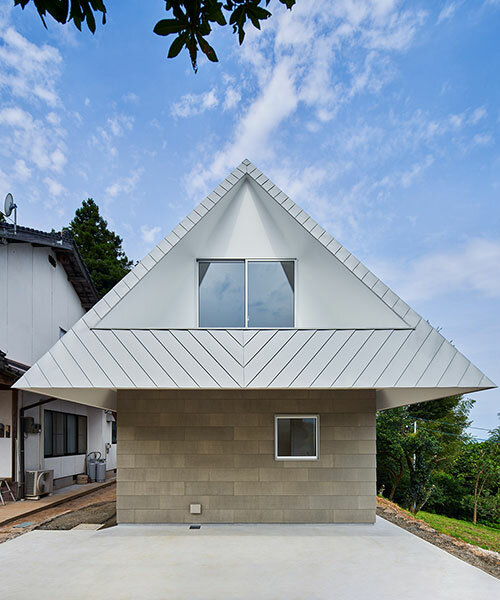 cut-out triangular roof frames extensive panoramas of rural japan