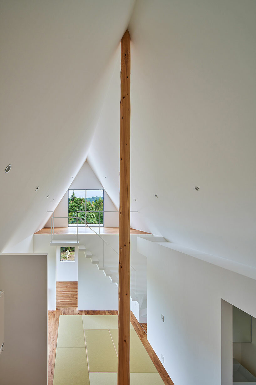 carved triangular roof frames expansive panoramas of rural japan